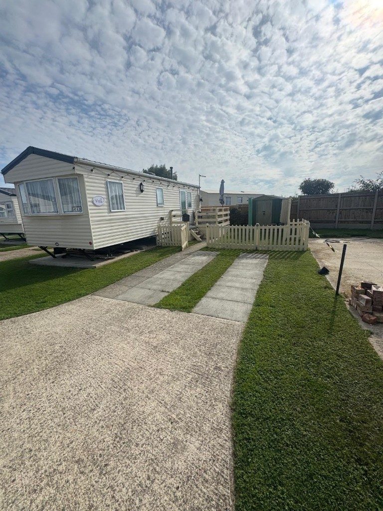 Freshly cut grass and a tidy path at a caravan pitch in Hampshire