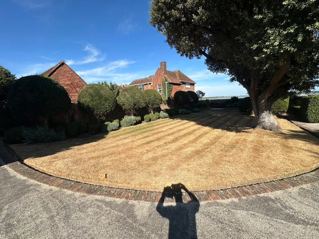 Striped lawn mown beside a waterside home on Hayling Island