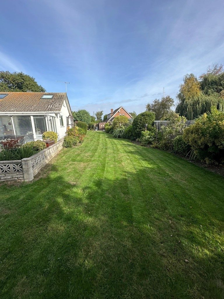 Striped lawn running the length of a garden after mowing in Hampshire