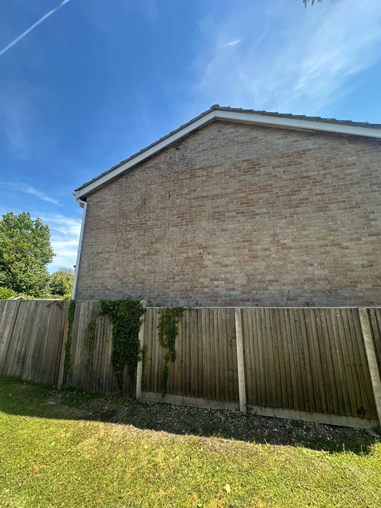 Clean brick house wall after EHW Landscapes removed the ivy in Hampshire